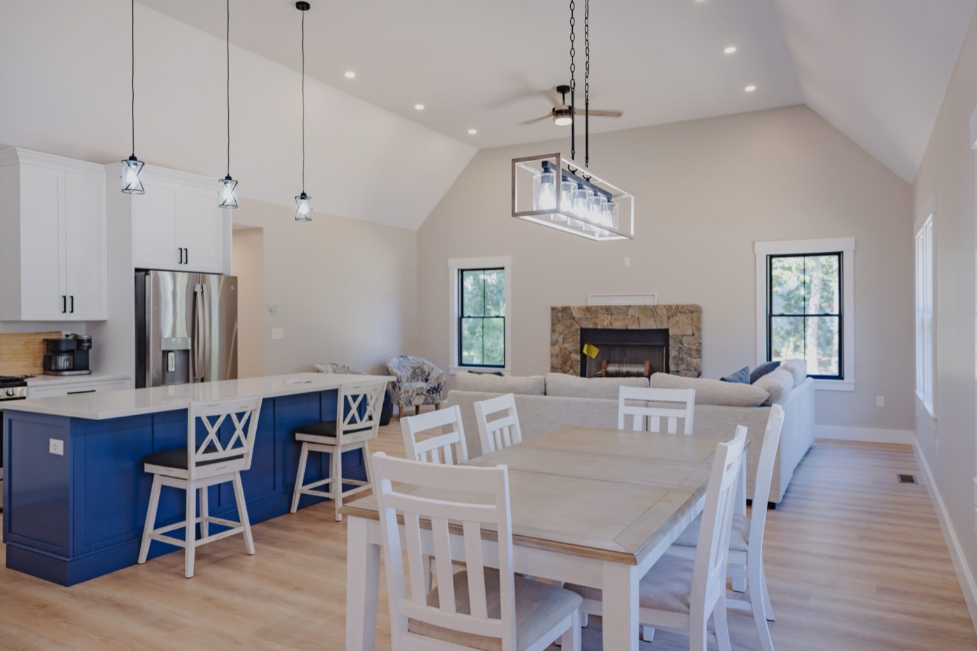 Open-plan kitchen and living room with pendant and recessed lighting